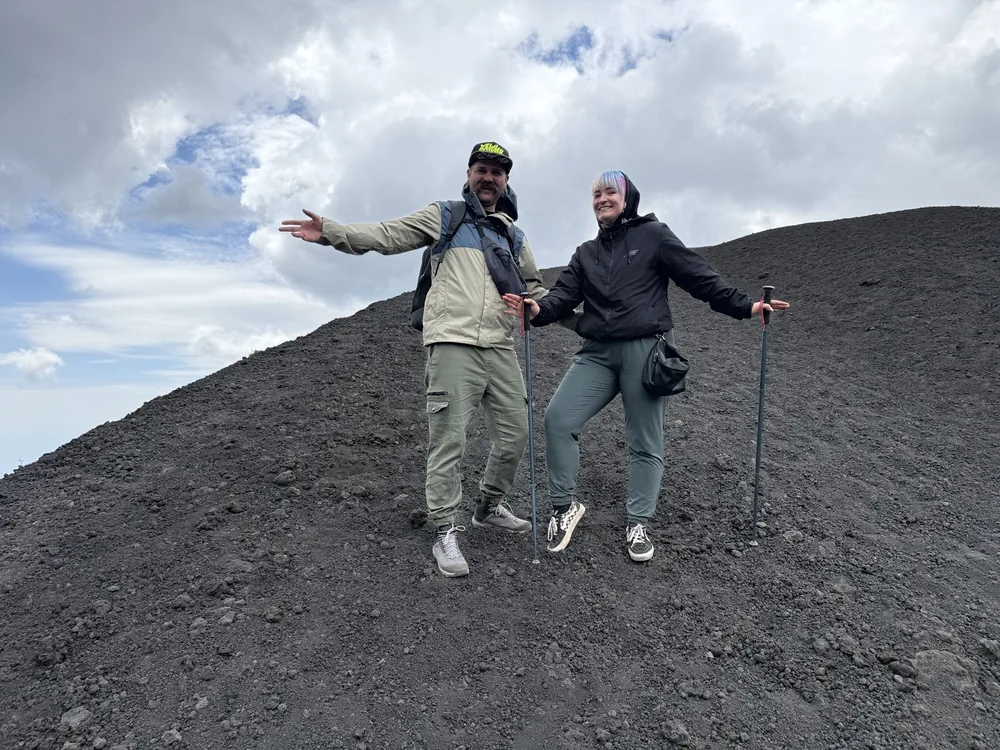 Hikers overlooking the craters of Mount Etna